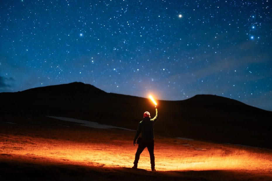 a man holding a light up in the air